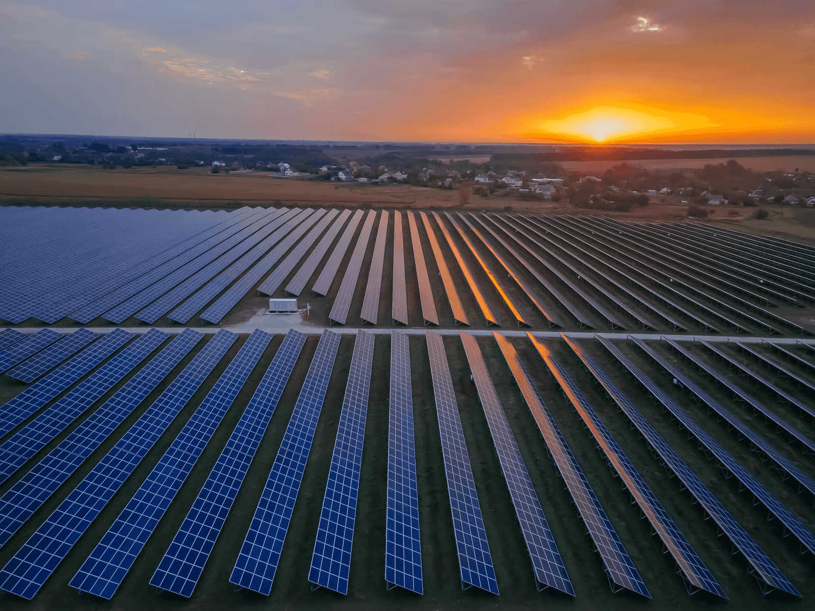 Aerial view of a solar farm at sunset